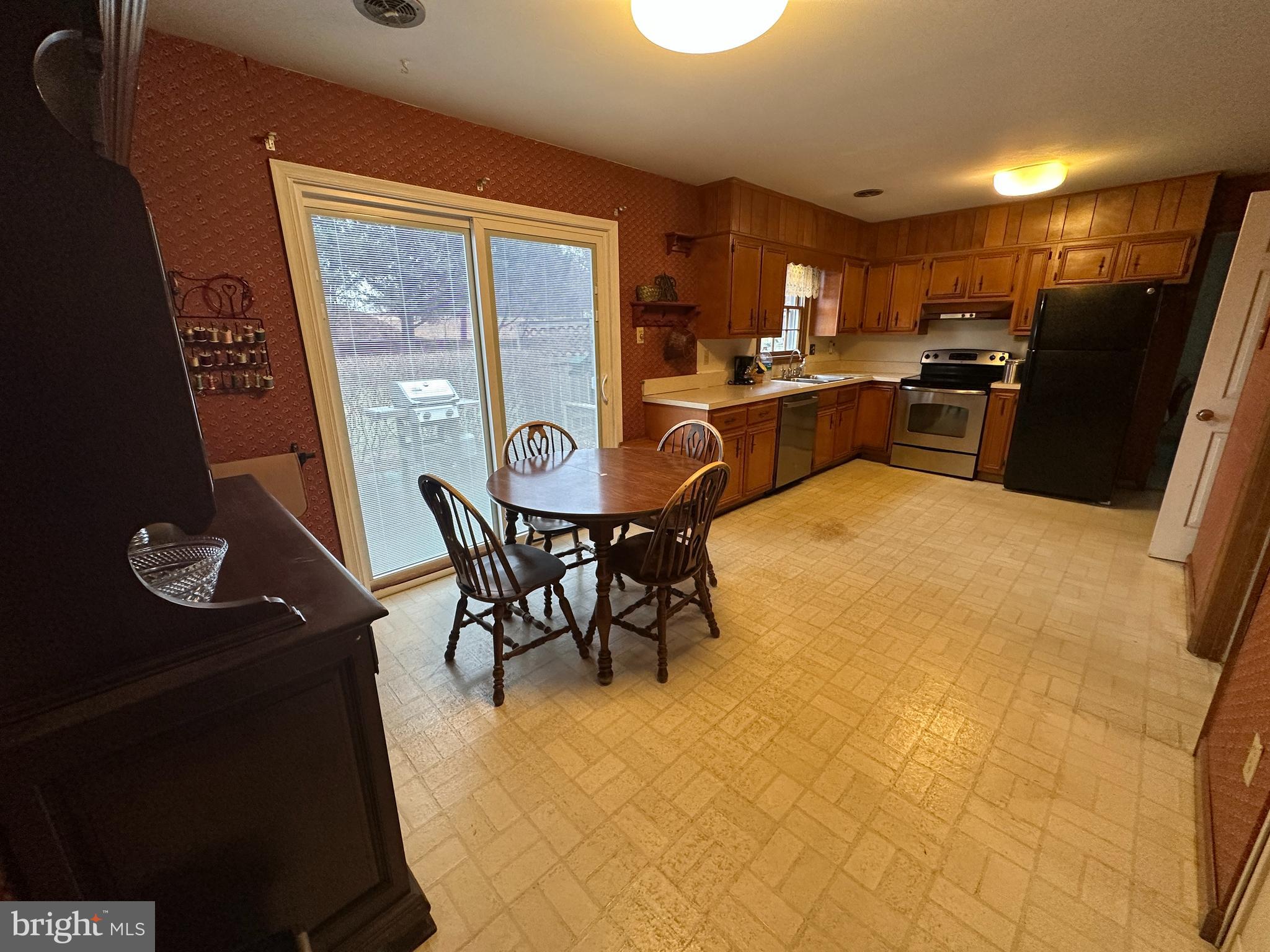 13632 Paradise Church Road Hagerstown, MD 21742 - Photo 16 of 47 a kitchen with stainless steel appliances granite countertop a refrigerator a stove top oven a sink with island and chairs