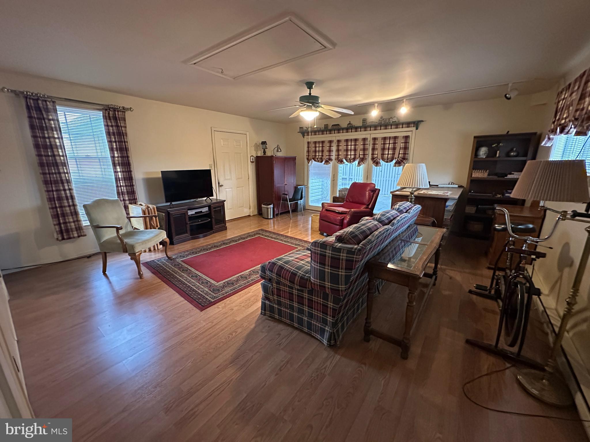 13632 Paradise Church Road Hagerstown, MD 21742 - Photo 23 of 47 a living room with furniture gym equipment and a flat screen tv