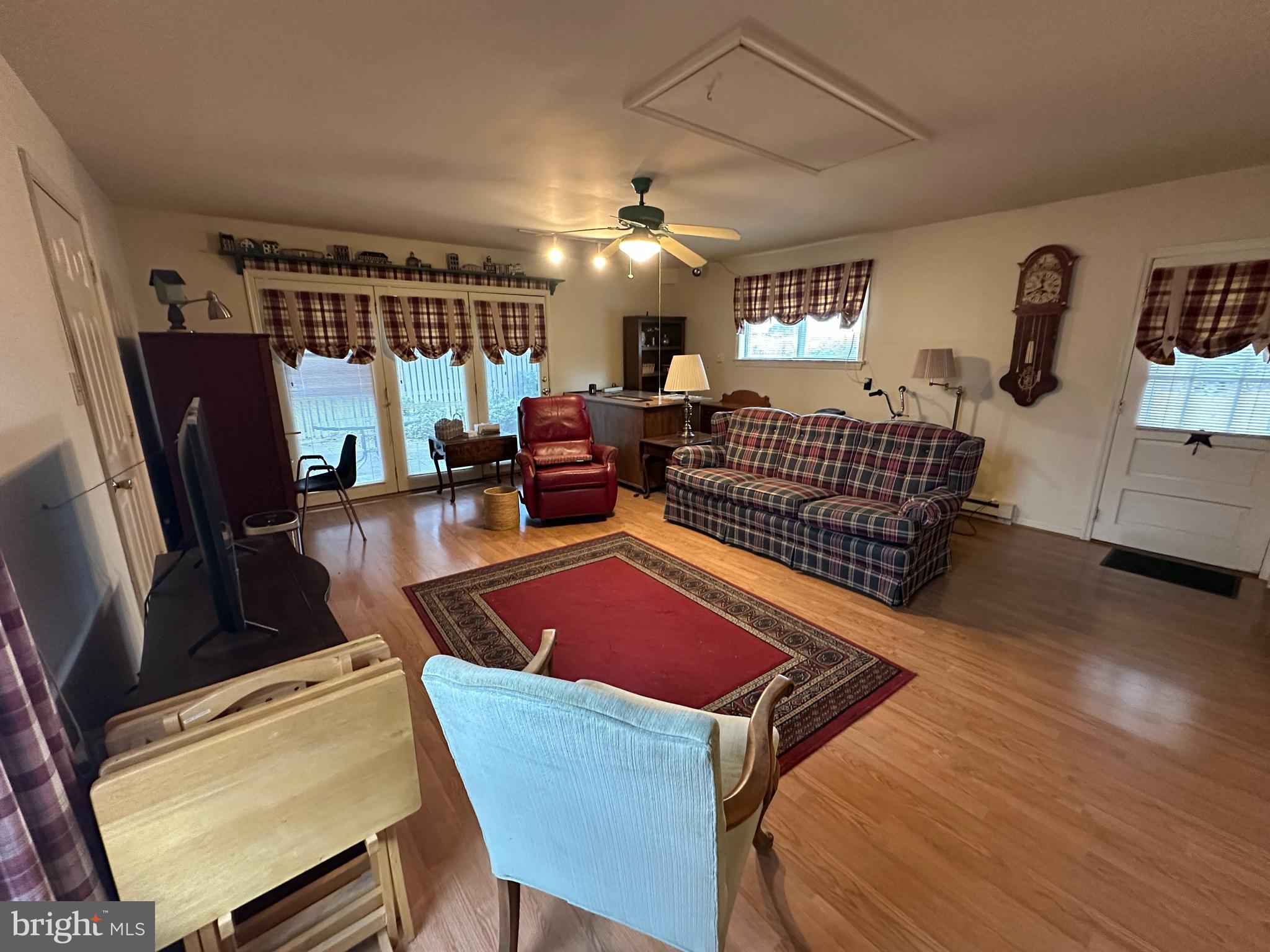 13632 Paradise Church Road Hagerstown, MD 21742 - Photo 24 of 47 a living room with furniture a rug and a flat screen tv
