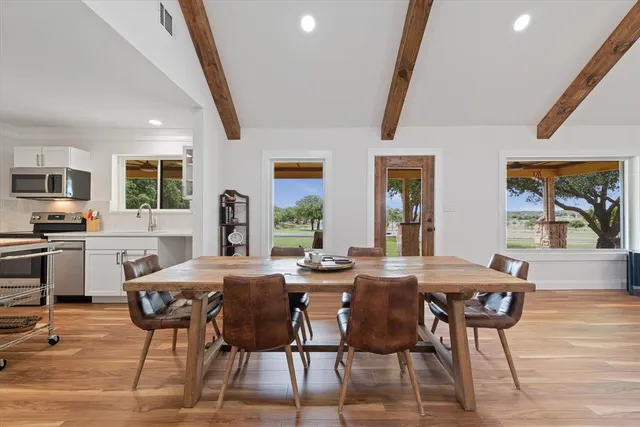 a view of a dining room with furniture and window