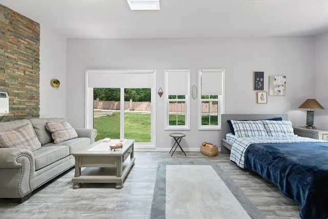 a bedroom with a bed and glass window