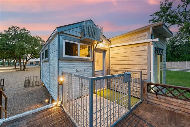 a view of a house with wooden deck outdoor seating