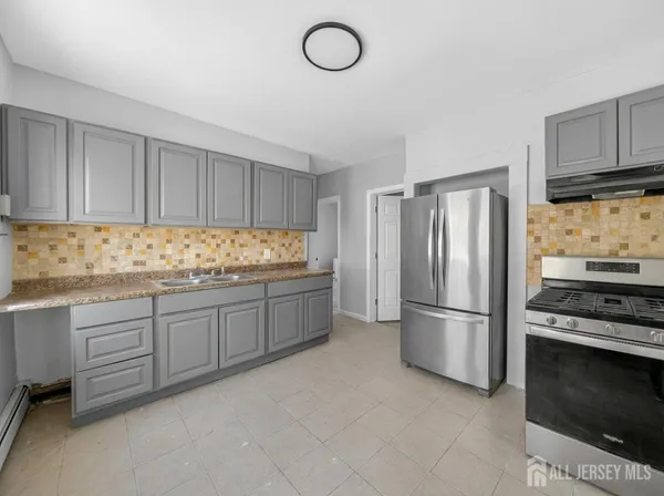 a kitchen with granite countertop stainless steel appliances and cabinets