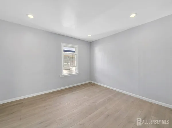 a room with a window and wooden floor