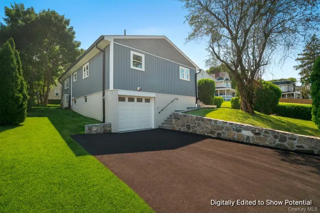 a front view of house with yard and green space