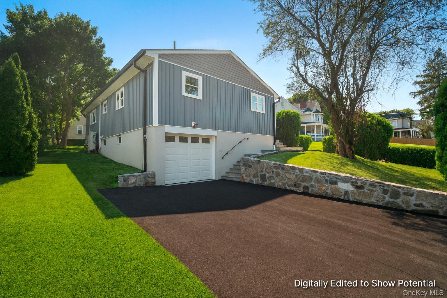 a front view of house with yard and green space