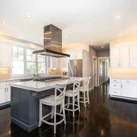 a kitchen with stainless steel appliances granite countertop a stove and a refrigerator