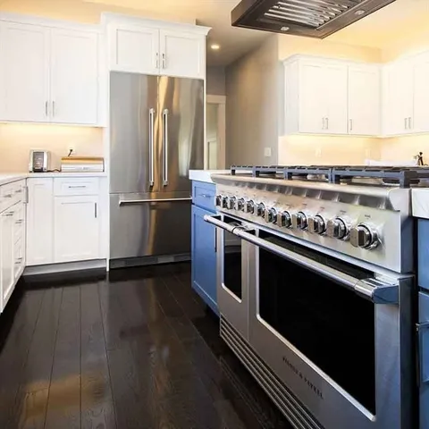 a kitchen with granite countertop a stove and a refrigerator