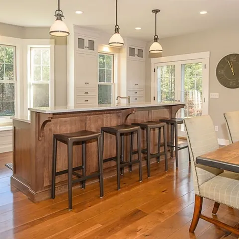 a view of a a dining room with furniture window and wooden floor