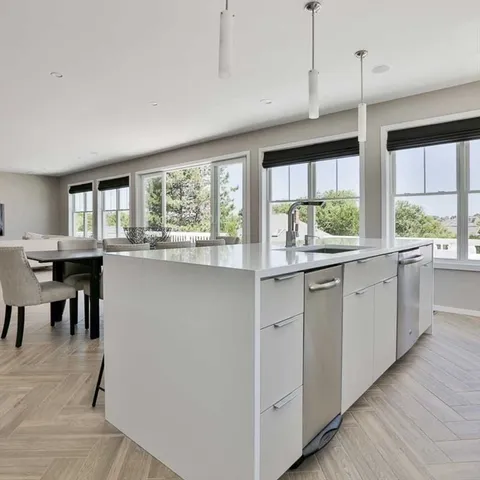 a kitchen with counter top space and wooden floor