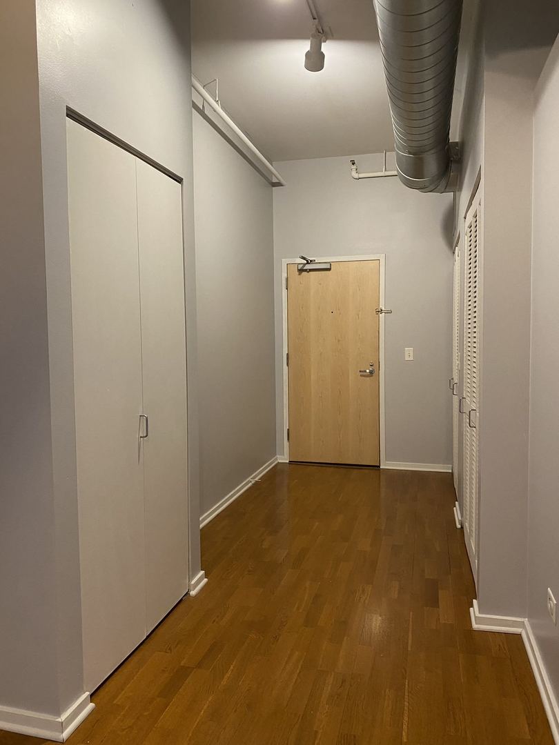 2323 West Pershing Road, Unit 601 Chicago, IL 60609 - Photo 11 of 21 an empty room with wooden floor
