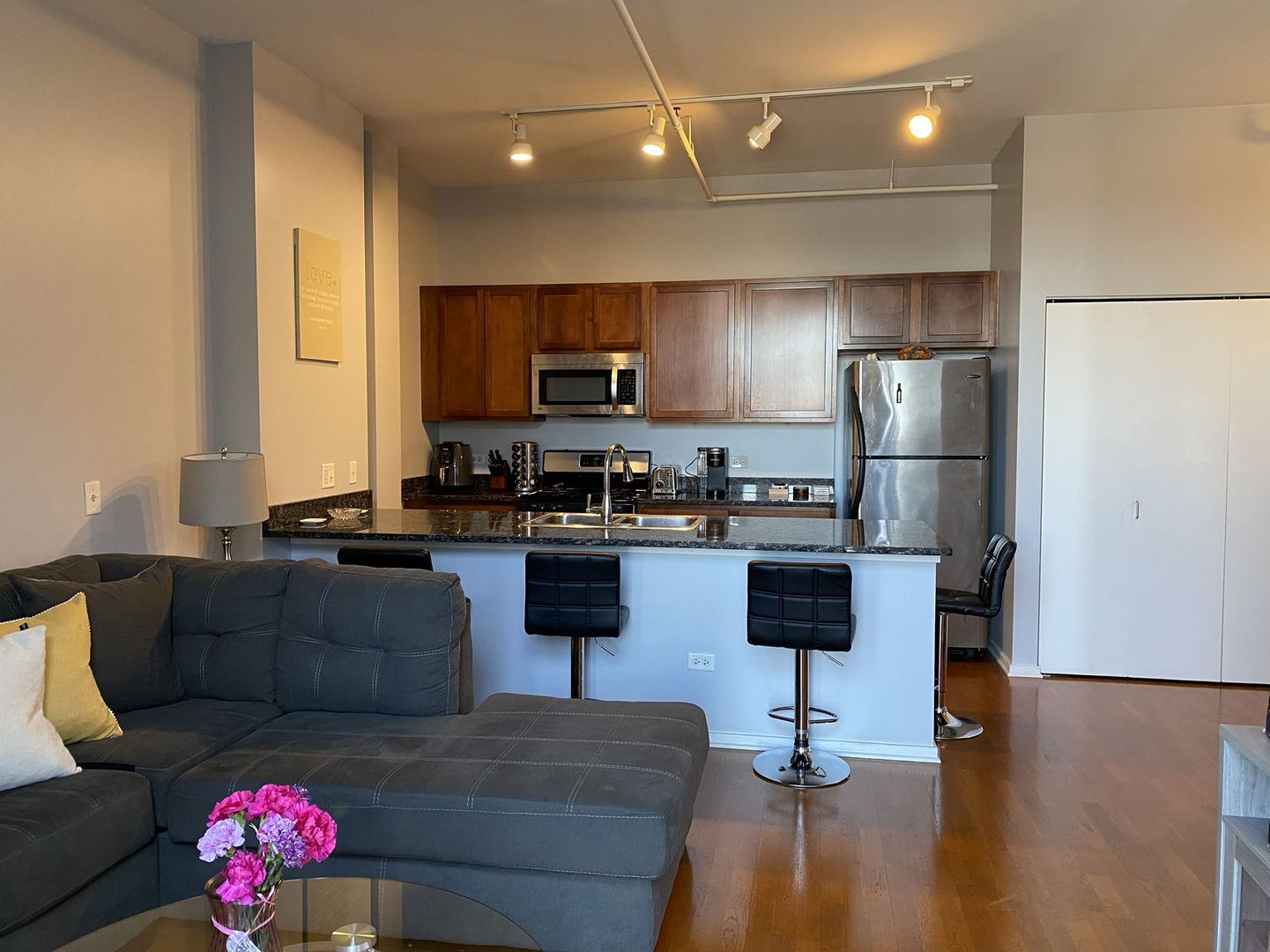 2323 West Pershing Road, Unit 601 Chicago, IL 60609 - Photo 15 of 21 a living room with furniture and a refrigerator