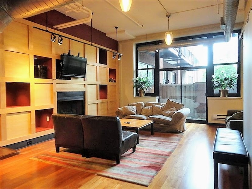 2323 West Pershing Road, Unit 601 Chicago, IL 60609 - Photo 5 of 21 a living room with furniture a flat screen tv and a fireplace