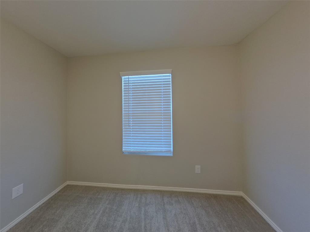 11856 Mancos Trail Rhome, TX 76078 - Photo 11 of 16 an empty room with a window