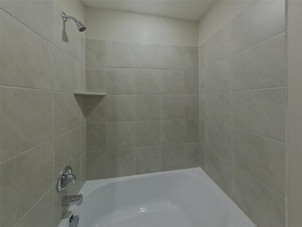 11856 Mancos Trail Rhome, TX 76078 - Photo 14 of 16 a bathroom with a bathtub