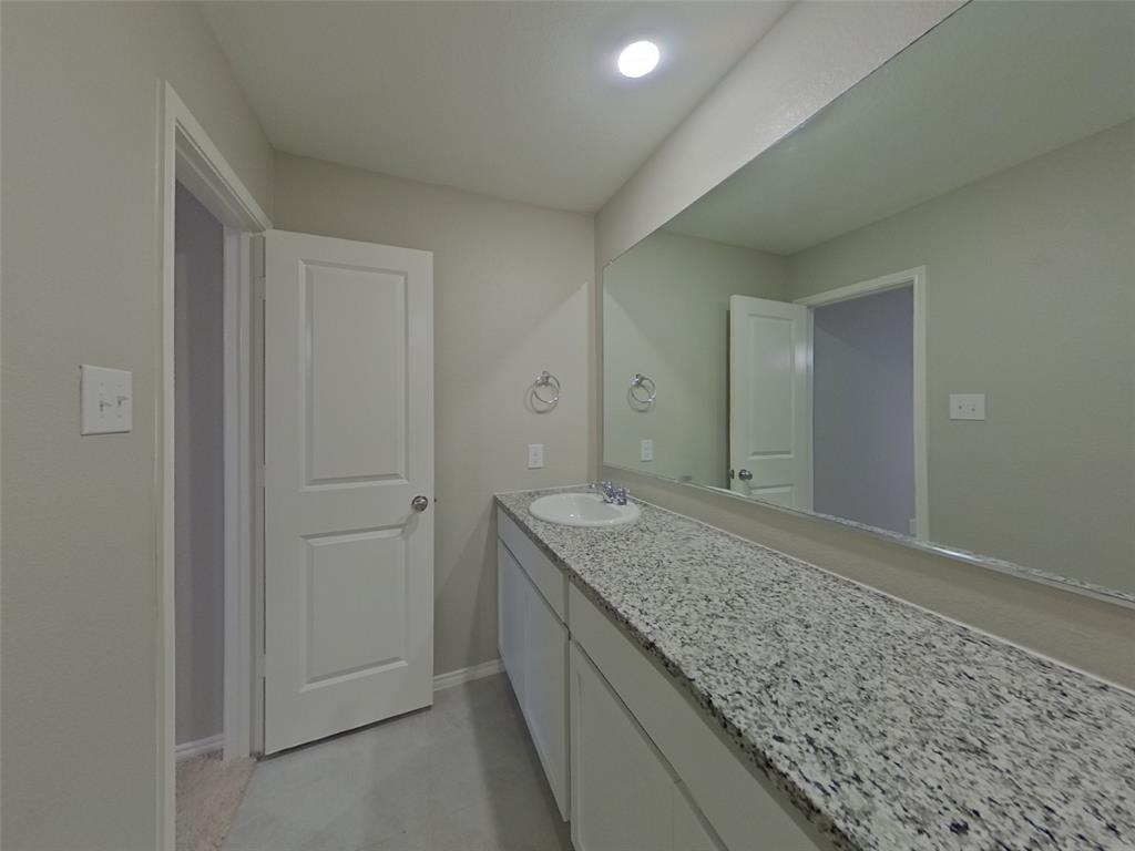11856 Mancos Trail Rhome, TX 76078 - Photo 8 of 16 a bathroom with a granite countertop sink and vanity