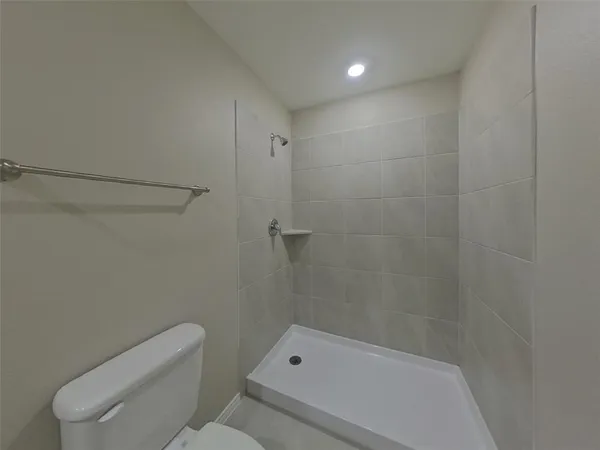 a bathroom with a toilet and shower