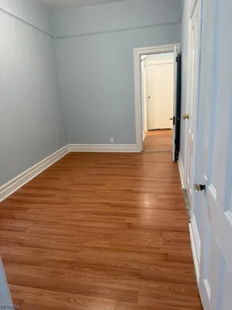 a view of room with wooden floor