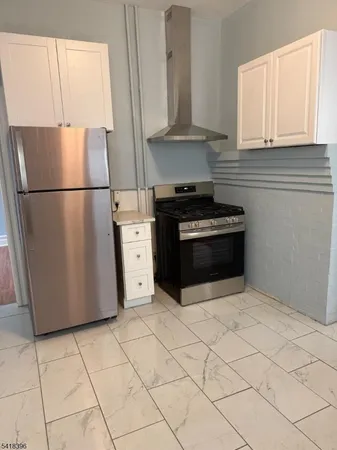 a kitchen with cabinets and stainless steel appliances