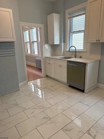 a kitchen with a sink cabinets and window
