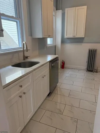 a kitchen with a sink and cabinets