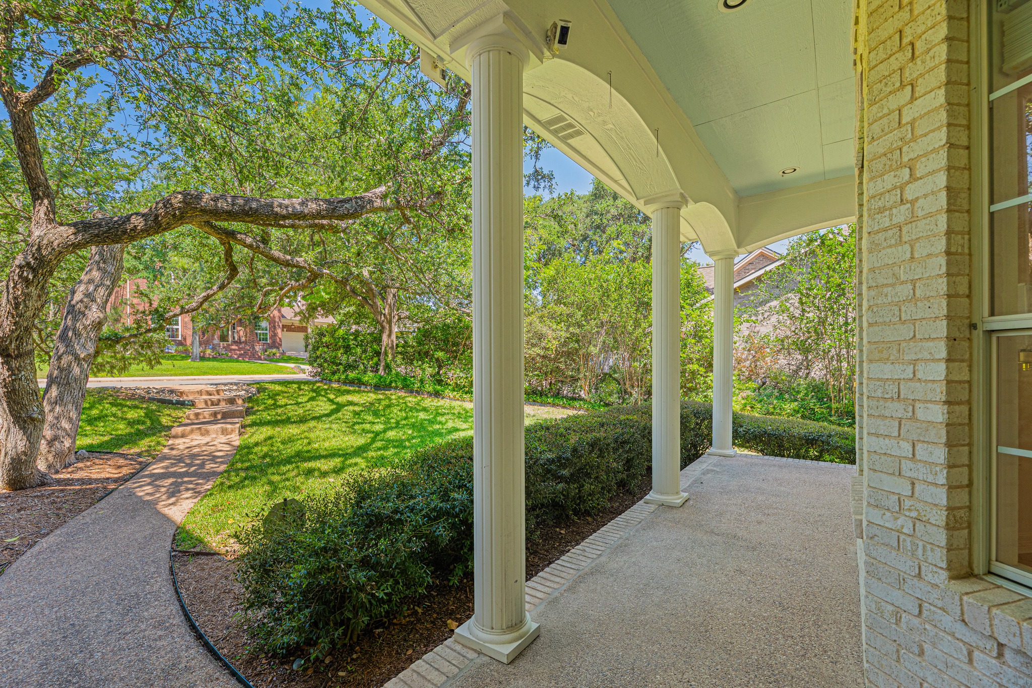 304 River Down Road Georgetown, TX 78628 - Photo 2 of 22 Inviting front porch featuring classic white columns and an exposed aggregate concrete surface