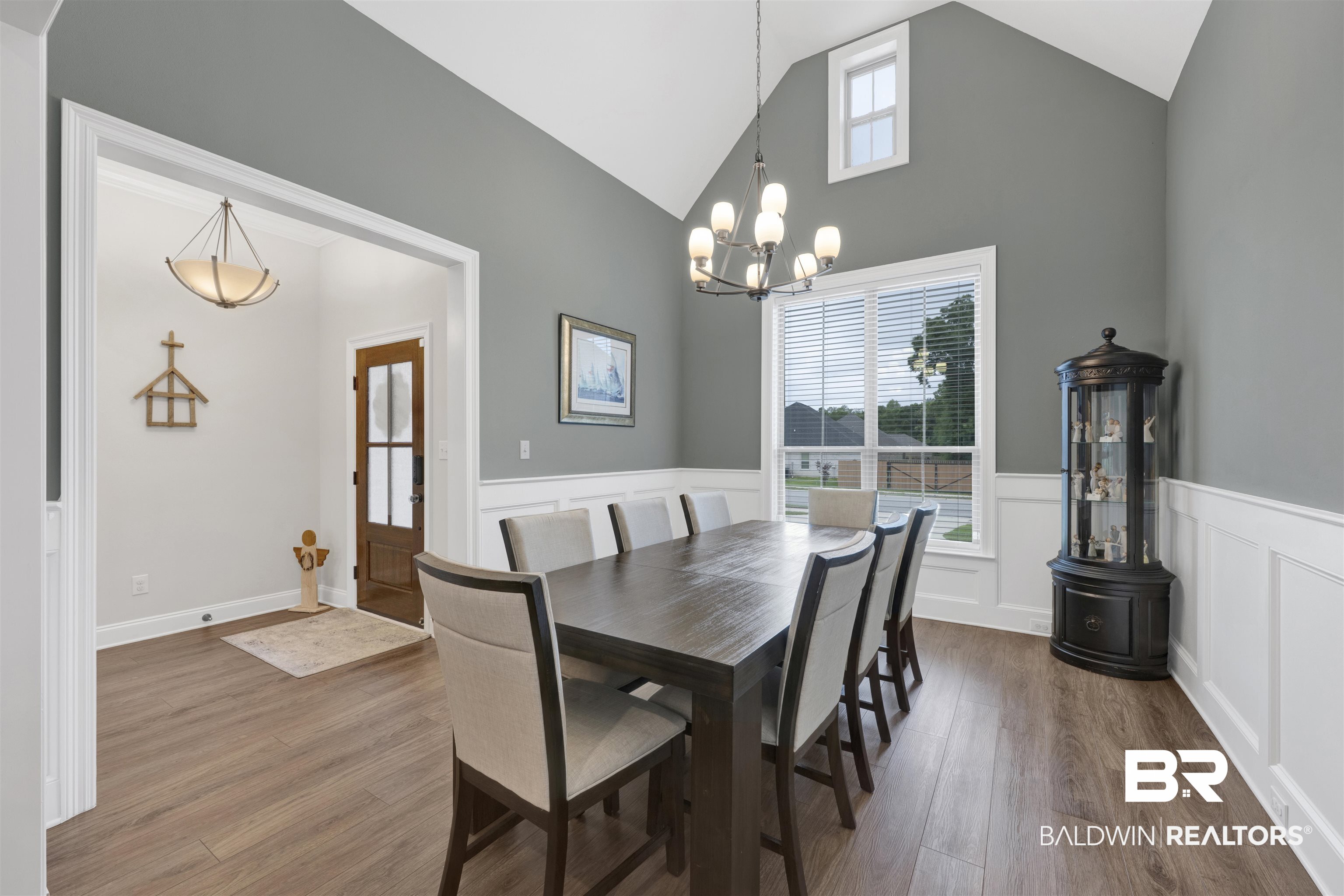 12672 Squirrel Drive Daphne, AL 36527 - Photo 4 of 49 Formal dining area featuring a vaulted ceiling, wood-finish flooring, wainscoting, and a prominent window