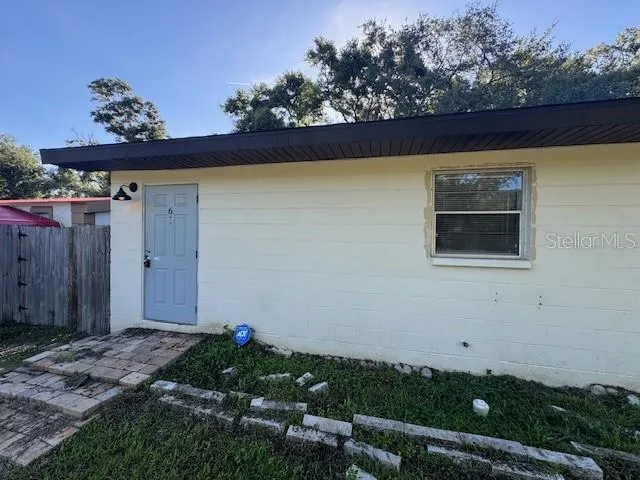 an empty room with closet and mirror