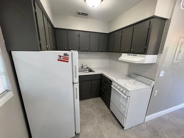 a utility room with wooden cabinets washer and dryer