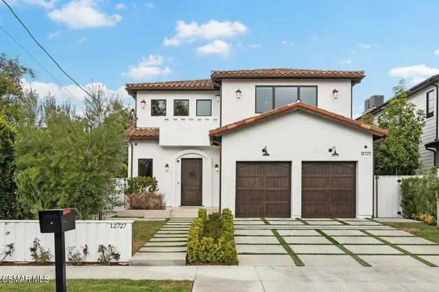 a front view of a house with garage