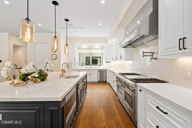 a bathroom with a double vanity sink mirror and toilet