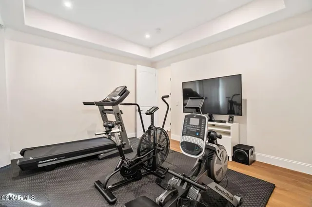 a bathroom with a granite countertop sink a toilet and a mirror