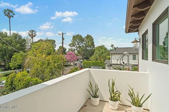 a bedroom with a large bed and a large window