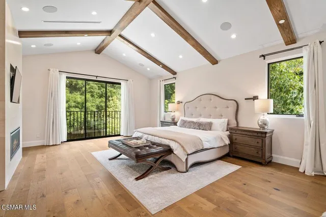 a bedroom with a bed couch and a window