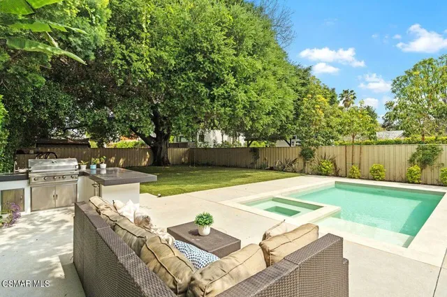 a view of a house with a yard and sitting area