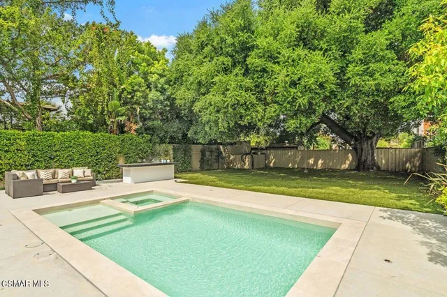 a view of a house with a yard and sitting area