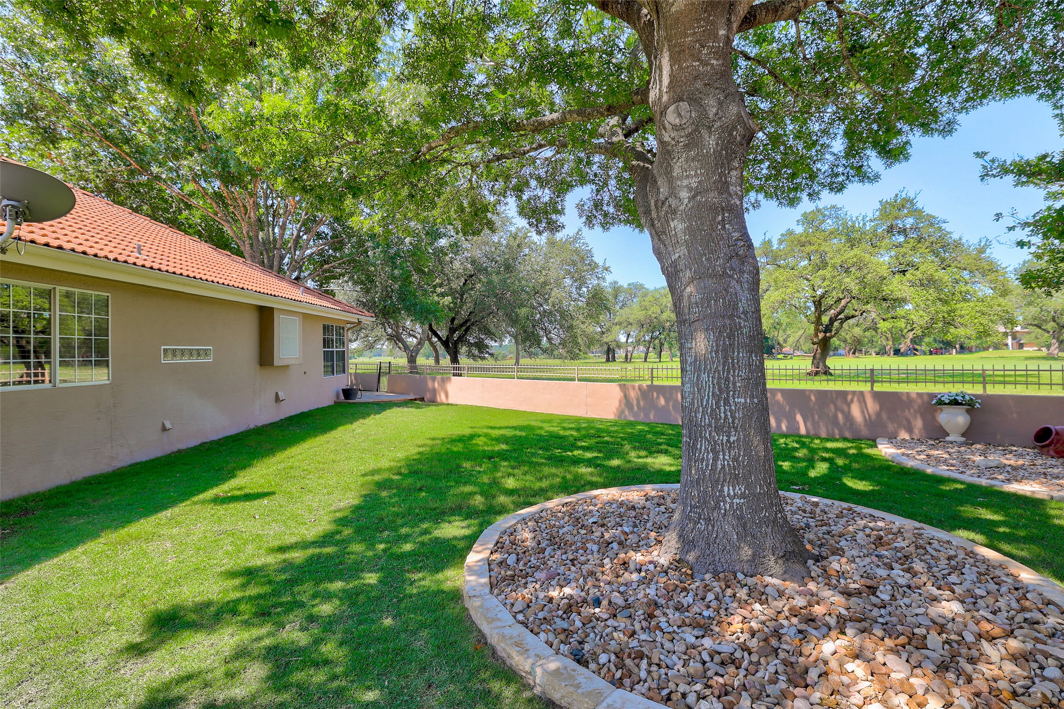 30107 Hamlet Circle Georgetown, TX 78628 - Photo 31 of 40 A well-maintained lawn and mature trees frame this delightful exterior, offering ample green space for enjoyment.