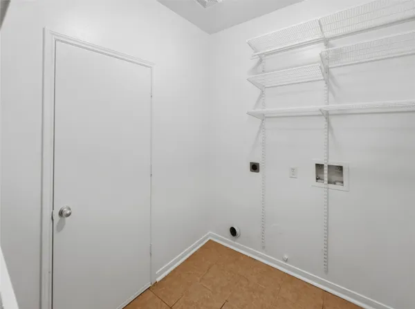 a kitchen with a sink a stove cabinets and a window