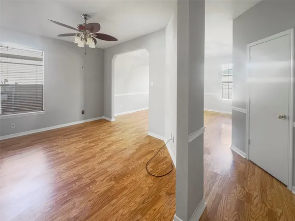 a view of an empty room with wooden floor