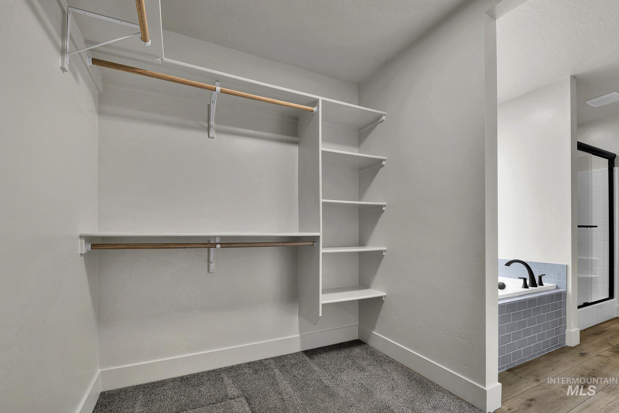 1130 Velvet Loop Wilder, ID 83676 - Photo 24 of 35 Walk-in closet featuring built-in shelving, dual hanging rods, and grey carpeting