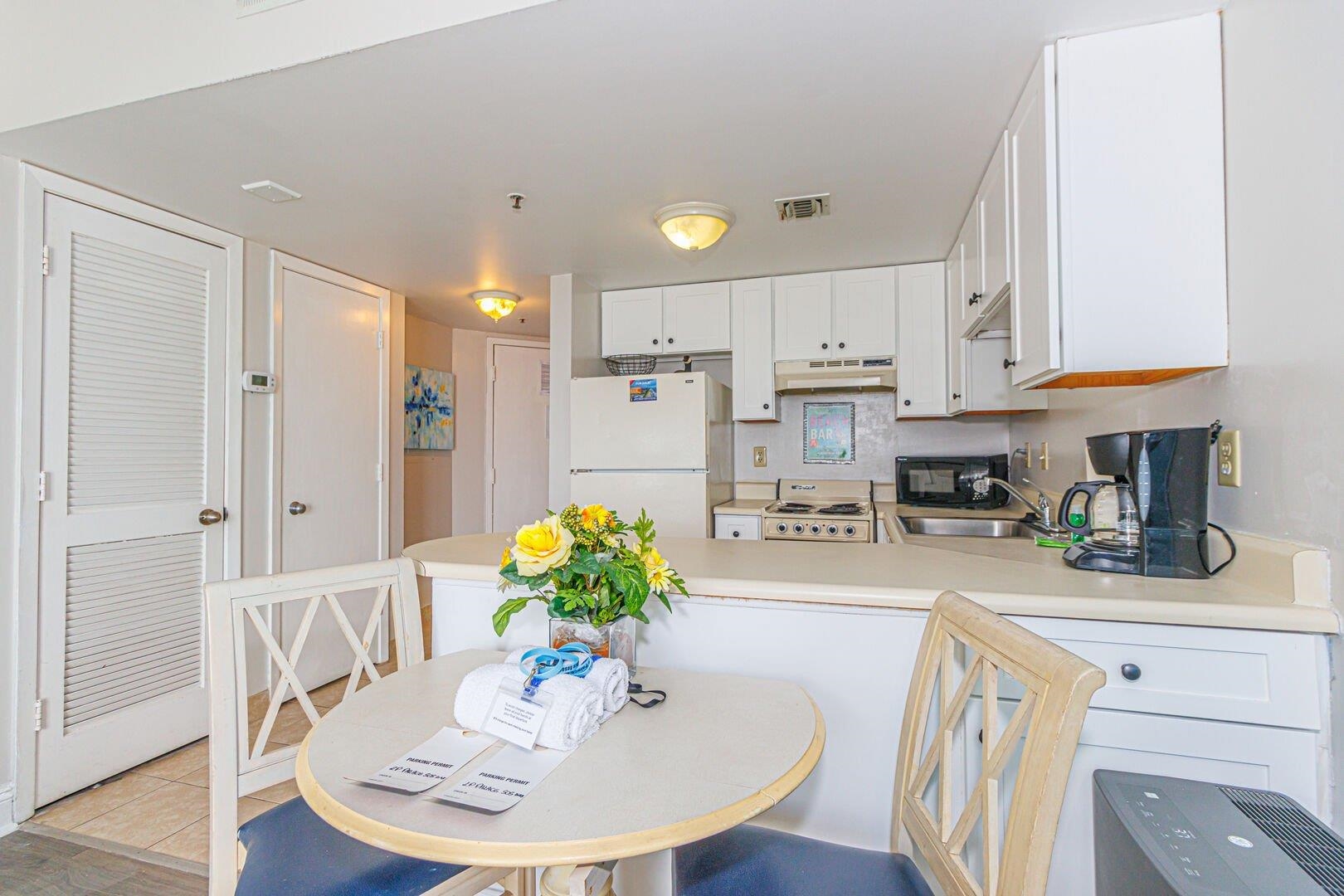 1605 South Ocean Boulevard, Unit 505 Myrtle Beach, SC 29577 - Photo 18 of 38 Kitchen with light countertops, freestanding refrigerator, white cabinetry, stove, and a peninsula