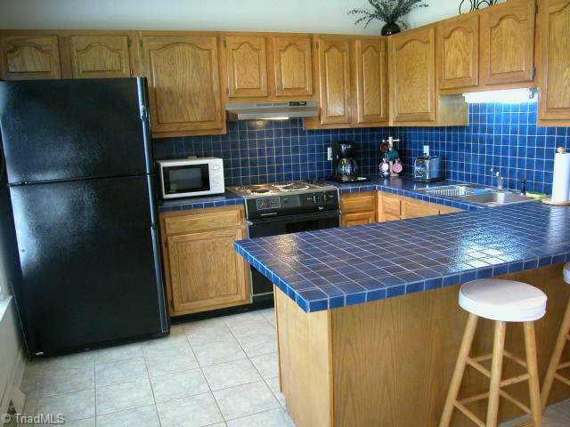 1141 Curt Boyles Road King, NC 27021 - Photo 5 of 9 Other. Kitchen w/tile floors, counters & backsplash