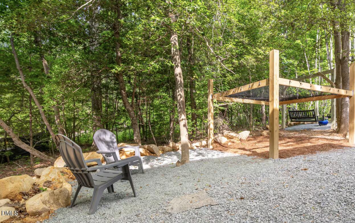 286 Stone Wall Road Pittsboro, NC 27312 - Photo 62 of 71 a view of a patio with a table chairs and a backyard