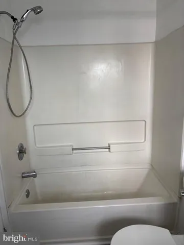 a bathroom with a bathtub and toilet
