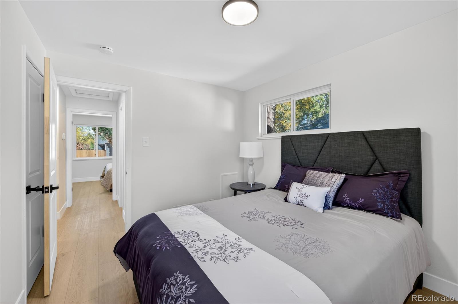 1856 South Steele Street Denver, CO 80210 - Photo 16 of 34 a bedroom with a bed and window