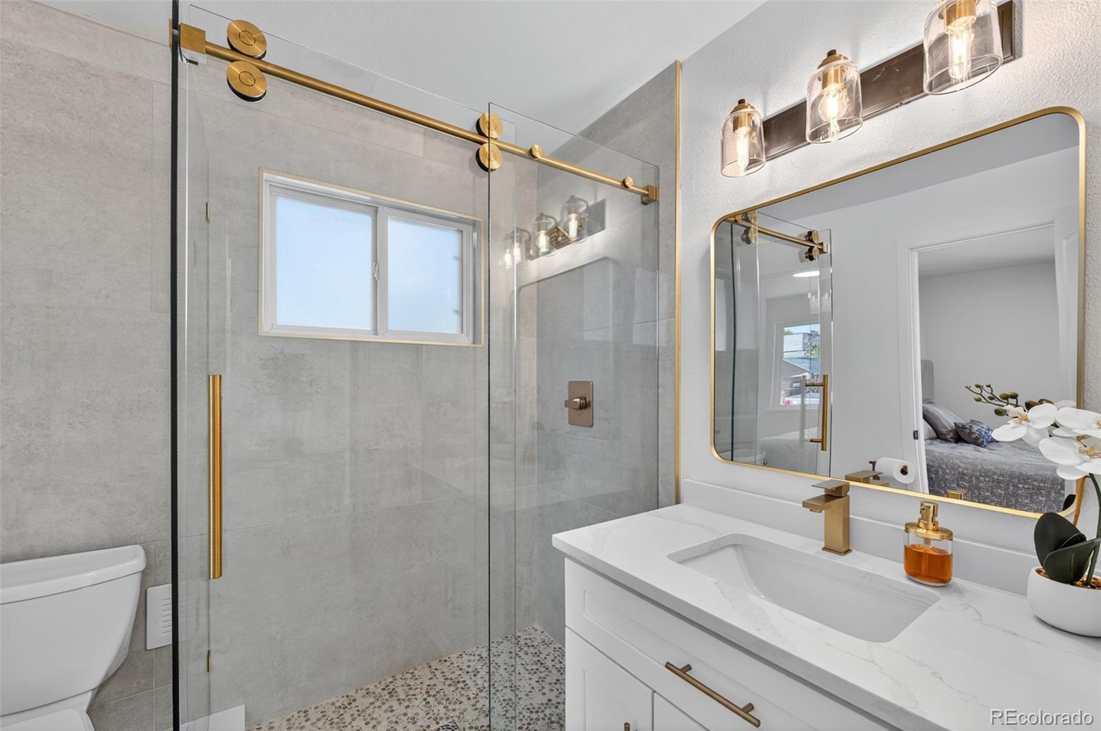 1856 South Steele Street Denver, CO 80210 - Photo 17 of 34 a bathroom with a sink toilet and shower