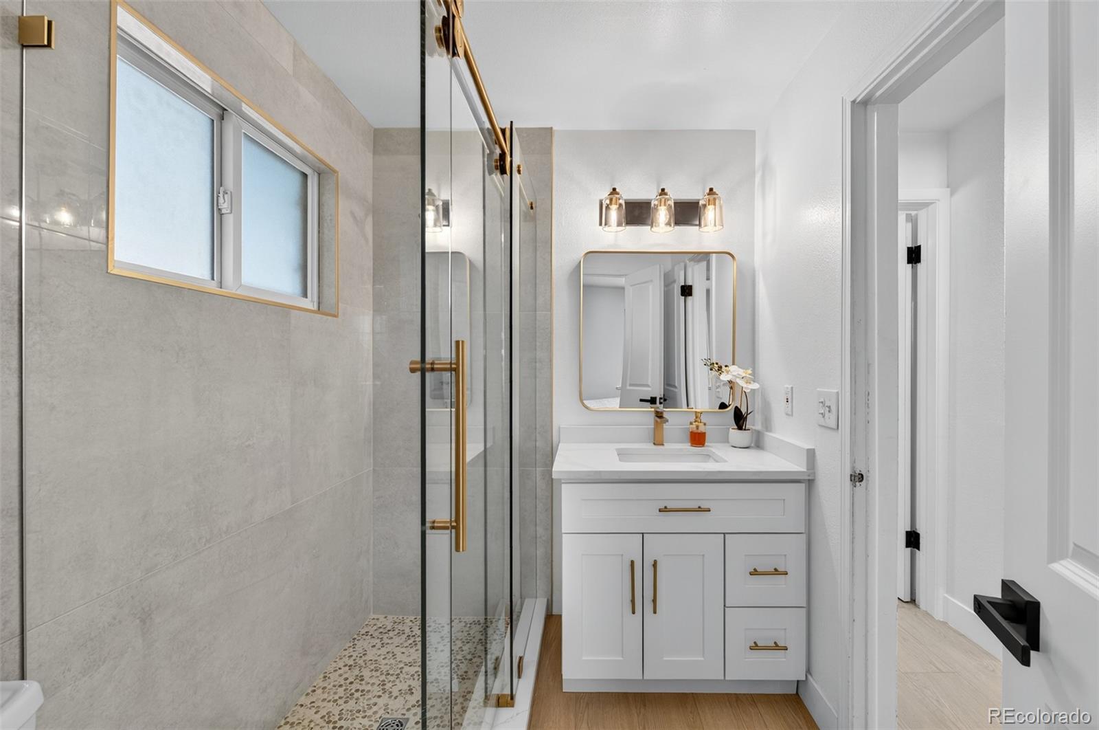 1856 South Steele Street Denver, CO 80210 - Photo 18 of 34 a bathroom with a sink and a mirror