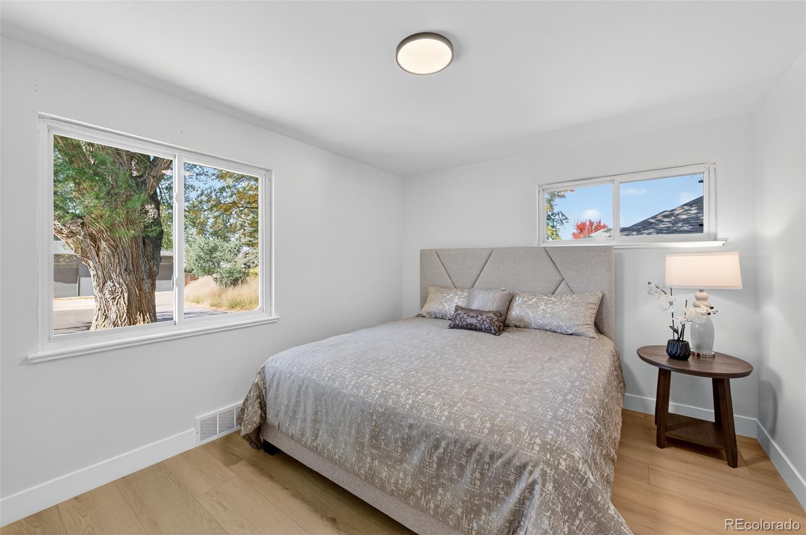 1856 South Steele Street Denver, CO 80210 - Photo 20 of 34 a bedroom with a bed and window
