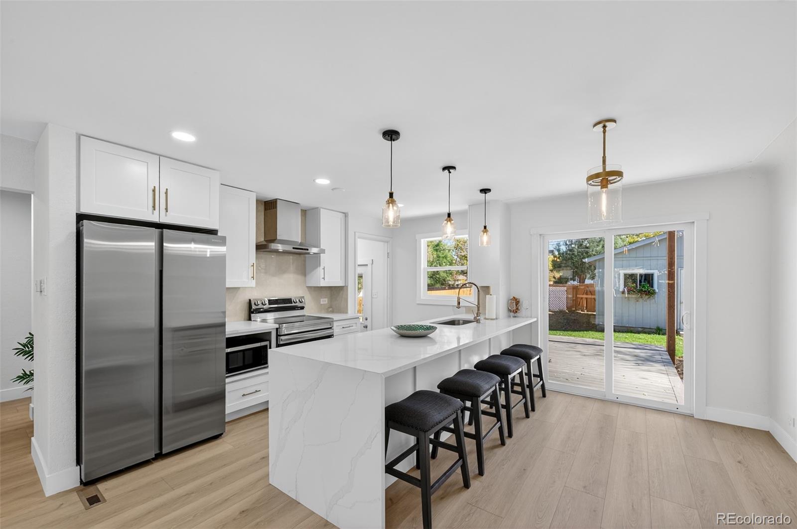1856 South Steele Street Denver, CO 80210 - Photo 2 of 34 a kitchen with counter top space and stainless steel appliances