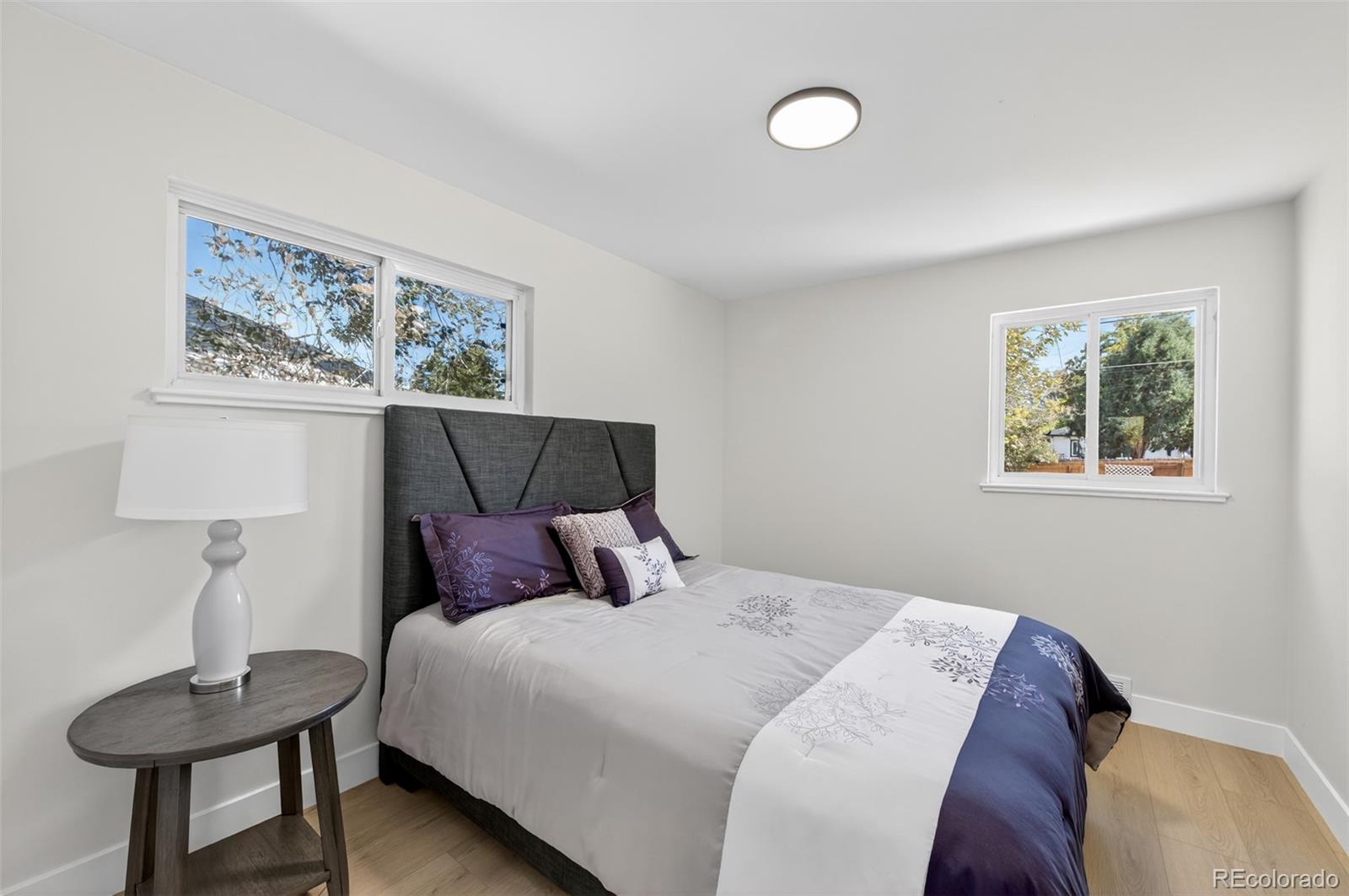 1856 South Steele Street Denver, CO 80210 - Photo 21 of 34 a bedroom with a bed and a painting on the wall